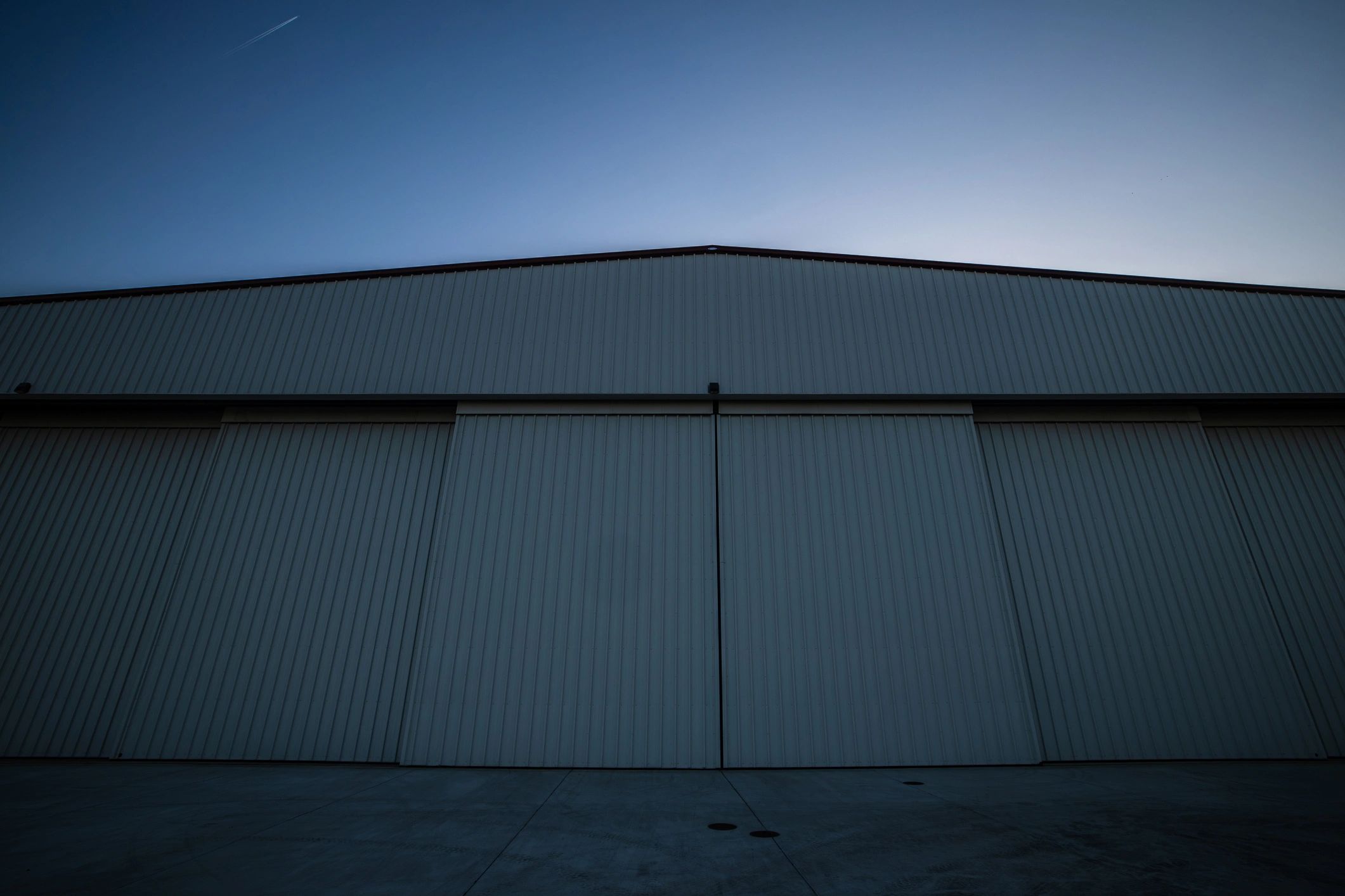 Aircraft hangar interior at sunset