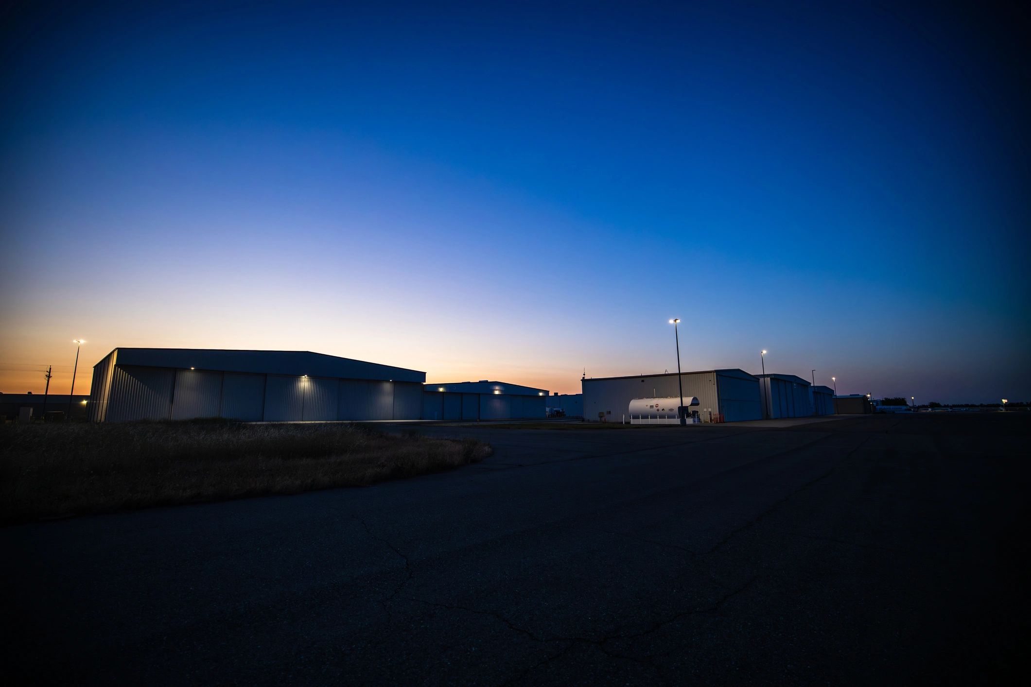 Business jet hangar exterior at dusk