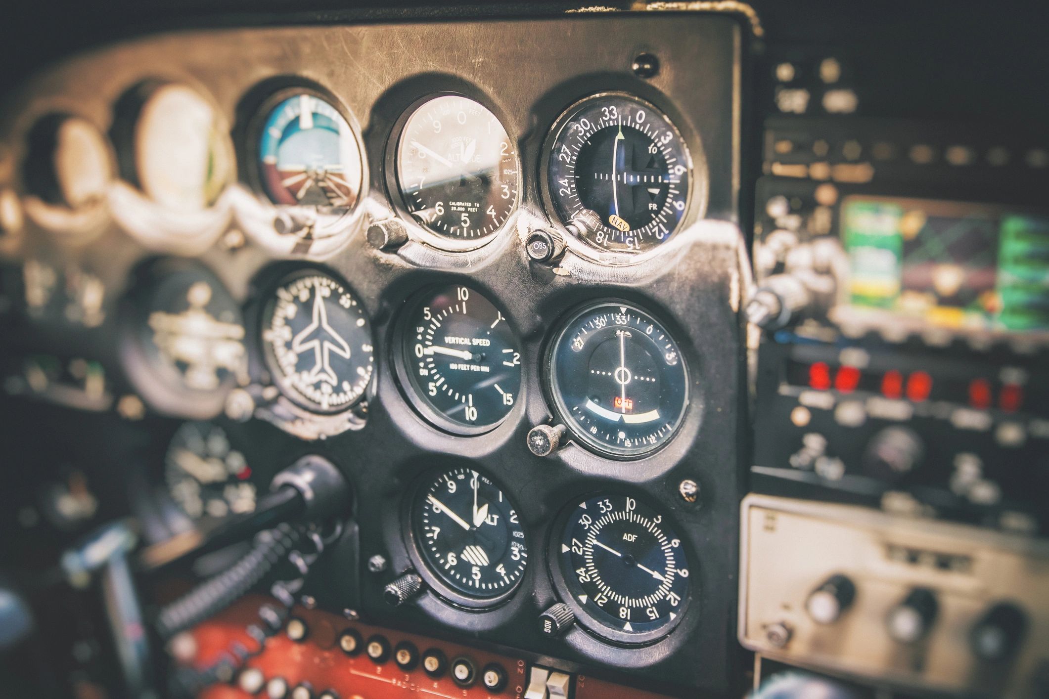 Close-up on flight instruments in old small airplane cockpit interior control panel in selective focus